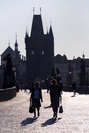 PRAGUE, CZECH REPUBLIC - SEPTEMBER 20 2018: Tourist walking on the Charles Bridge with Town Bridge Tower in background on September 20, 2018 in Prague, Czech Republic.のeditorial素材
