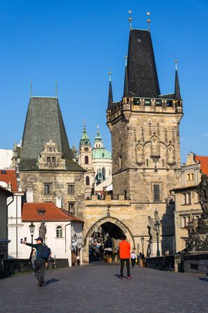 PRAGUE, CZECH REPUBLIC - SEPTEMBER 20 2018: Tourist walking on the Charles Bridge with Town Bridge Tower in background on September 20, 2018 in Prague, Czech Republic.のeditorial素材