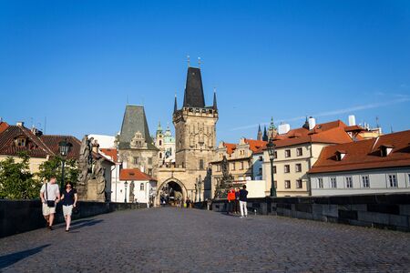 PRAGUE, CZECH REPUBLIC - SEPTEMBER 20 2018: Tourist walking on the Charles Bridge with Town Bridge Tower in background on September 20, 2018 in Prague, Czech Republic.のeditorial素材