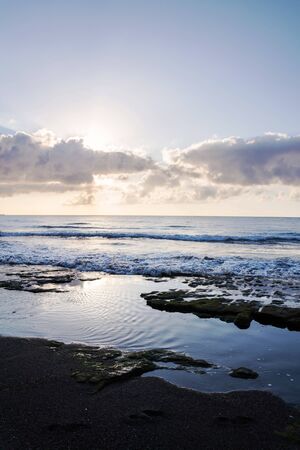 Breathtaking sunrinse on beach in El Medano, Tenerife, Canary Islands, Spain, sunny cloudy blue sky with copy spaceの写真素材