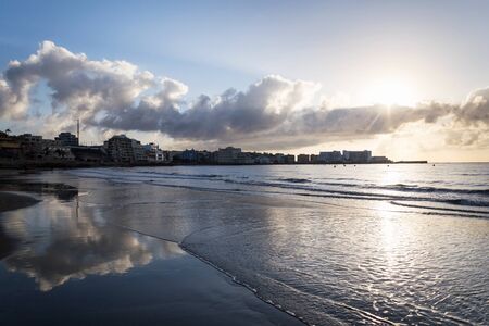 Breathtaking sunrinse on beach in El Medano, Tenerife, Canary Islands, Spain, sunny cloudy blue sky with copy spaceの写真素材