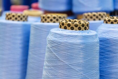 Colorful thread reels set up for sewing machine, textile industry factory concept 