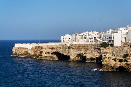 Houses on dramatic cliffs over Adriatic sea in Polignano a Mare, Italy, sunny summer dayの写真素材