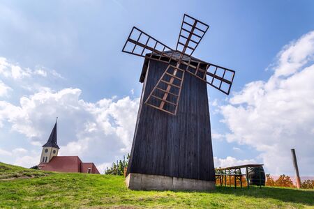 Traditional wooden windmill, Vrbice, Breclav district, Southern Moravia, Czech Republic, sunny summer dayの写真素材