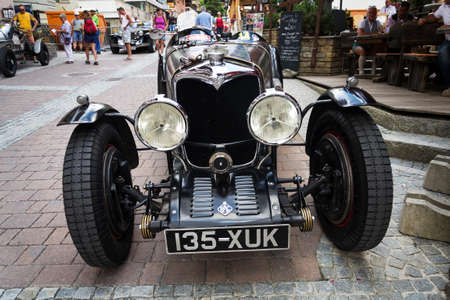 SAALBACH-HINTERGLEMM, AUSTRIA - JUNE 21 2018: People looking at vintage veteran car on June 21, 2018 in Saalbach-Hinterglemm, Austria.のeditorial素材