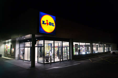 PRAGUE, CZECH REPUBLIC - APRIL 3 2020: LIDL company logos at night on supermarket building from German chain, part of Schwartz Gruppe on April 3, 2020 in Prague, Czech Republic.のeditorial素材