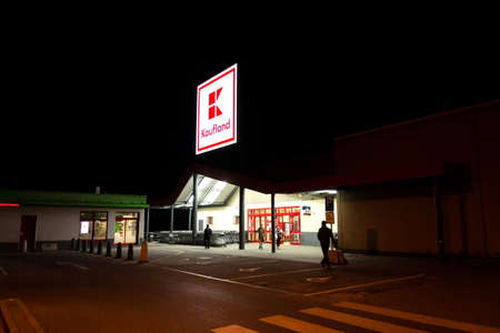 PRAGUE, CZECH REPUBLIC - APRIL 3 2020: Kaufland company logo at night on supermarket building from German chain, part of Schwartz Gruppe on April 3, 2020 in Prague, Czech Republic.のeditorial素材