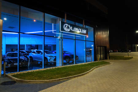 PRAGUE, CZECH REPUBLIC - APRIL 3 2020: Lexus company logo on dealership building, luxury vehicle division of Japanese automaker Toyota at night on April 3, 2020 in Prague, Czech Republic.のeditorial素材