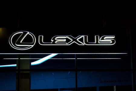 PRAGUE, CZECH REPUBLIC - APRIL 3 2020: Lexus company logo on dealership building, luxury vehicle division of Japanese automaker Toyota at night on April 3, 2020 in Prague, Czech Republic.のeditorial素材