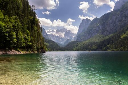 Vorderer Gosausee lake near Gosau with melting glacier in background, Austria, sunny summer dayの写真素材