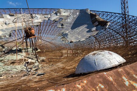Old satellite dish antenna in dry adir land near El Medano, Tenerife, Canary Islands, Spain, telecommunication and wireless communication security conceptの写真素材
