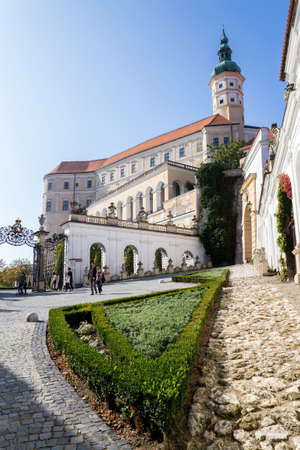 MIKULOV, CZECH REPUBLIC - OCTOBER 13 2019: People walk on streets with Mikulov castle in background on October 13, 2019 in Mikulov, Czech Republic.のeditorial素材