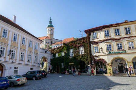 MIKULOV, CZECH REPUBLIC - OCTOBER 13 2019: People walk on streets with Mikulov castle in background on October 13, 2019 in Mikulov, Czech Republic.のeditorial素材