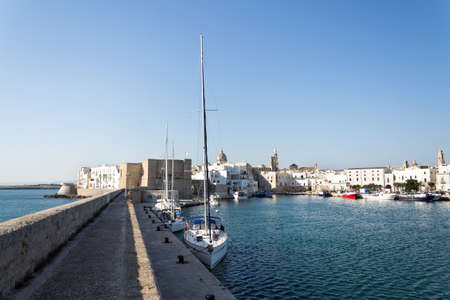 Beautiful boats in Monopoli port near Castle of Carlo V with church in background, Apulia, Bari province, Italyのeditorial素材