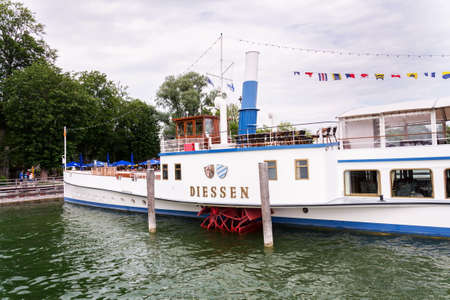 INNING AM AMMERSEE, GERMANY - JULY 6 2019: Paddle Steamer Diessen floating by pier on the lake Ammersee on July 6, 2019 in Inning am Ammersee, Germany.のeditorial素材