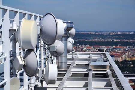 Construction for 5G broadband cellular network transmitters, telecommunication tower, wireless communication concept, clear blue sky background with copy spaceの写真素材