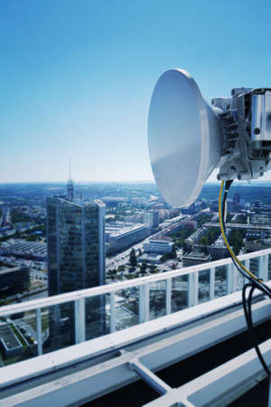 Construction for 5G broadband cellular network transmitters, telecommunication tower, wireless communication concept, clear blue sky background with copy spaceの写真素材