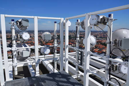 Construction for 5G broadband cellular network transmitters, telecommunication tower, wireless communication concept, clear blue sky background with copy spaceの写真素材