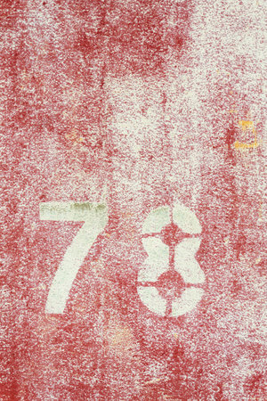 Number 78 on vintage rusty red and white metal sheet plateの写真素材