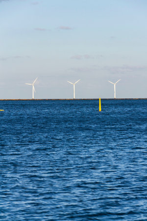 White turbines of Middelgrunden wind farm outside Copenhagen, Denmark, sustainable renewable...