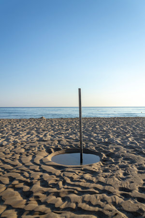 Water disappearing in sand on the beach, water shortage scarcity conceptの写真素材