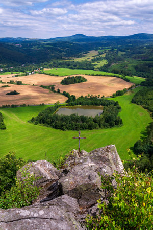 Pond in a beautiful landscape with forests, meadows and fields below Semnicka skala in the protected landscape area Slavkovsky forest near Karlovy Vary, Doupovske mountains, Czech Republic, sunny summer dayの写真素材