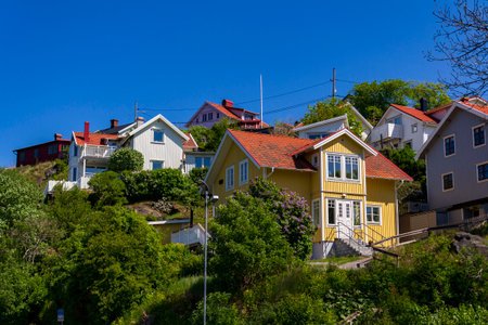 Picturesque colony of old small wooden historic houses on the Slottsberget mountain on the banks of the Gota alv river, Gothenburg, Sweden, sunny dayの写真素材