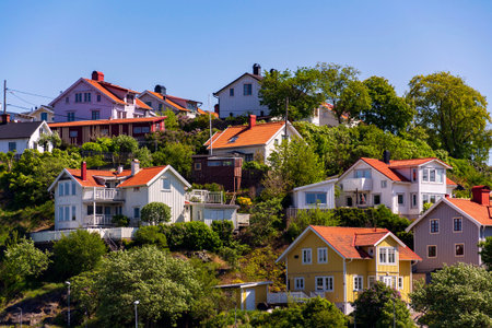 Picturesque colony of old small wooden historic houses on the Slottsberget mountain on the banks of the Gota alv river, Gothenburg, Sweden, sunny dayの写真素材