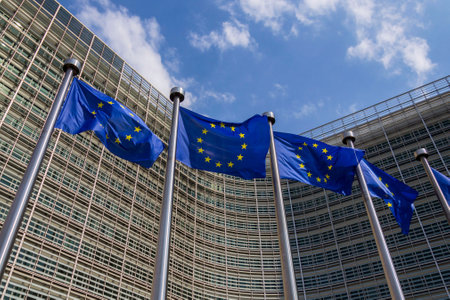 Waving EU flags in front of the Berlaymont building headquarters of the European Commission in Brussels, Belgiumの写真素材