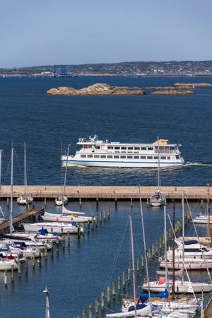 rchipelago ferry leaving harbor with ships at Saltholmen peninsula on the shore of Alvsborgsfjorden, Alvsborg district on May 13, 2025 in Gothenburg, Sweden.の写真素材