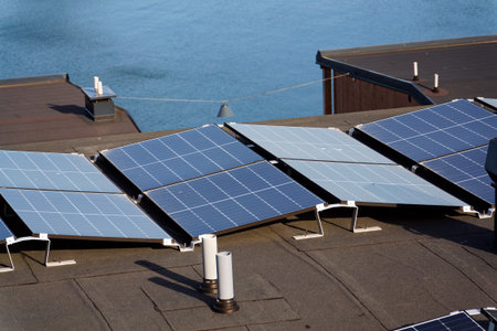 Solar panels on roof of apartment housing building, renewable green sustainable energy concept,...