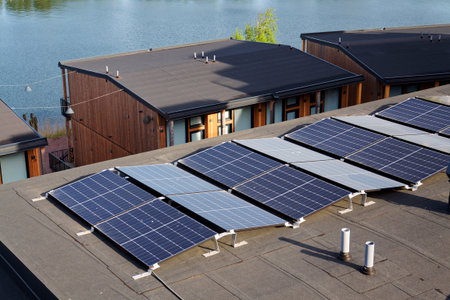 Solar panels on roof of apartment housing building, renewable green sustainable energy concept, water cooling, aerial viewの写真素材