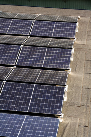 Solar panels on roof of apartment building, renewable green sustainable energy concept, water...
