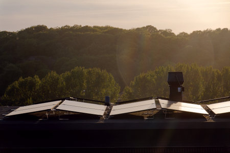 Solar panels on roof of apartment building, renewable green sustainable energy concept, water...