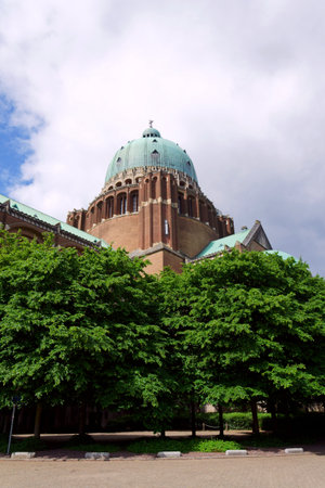 The National Basilica of the Sacred Heart, Sacre-Coeur, majestic dome, stone architecture, blue sky, Brussels, Belgiumの写真素材