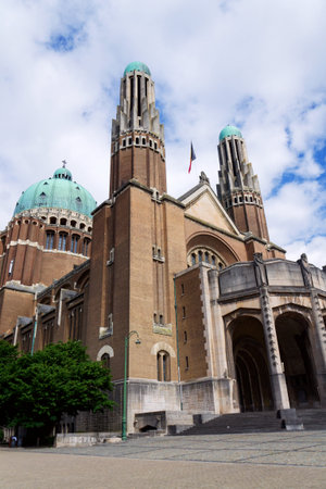 The National Basilica of the Sacred Heart, Sacre-Coeur, majestic dome, stone architecture, blue sky, Brussels, Belgiumの写真素材