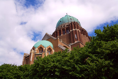 The National Basilica of the Sacred Heart, Sacre-Coeur, majestic dome, stone architecture, blue sky, Brussels, Belgiumの写真素材
