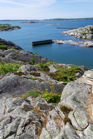 Rocks around public sea bath of Saltholmen peninsula on shore of Alvsborgsfjorden harbor, Alvsborg district, sunny day, Gothenburg, Swedenの写真素材
