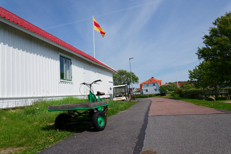Flatbed moped parked on street of the peaceful car-free Vrango island with seaside village in Gothenburg archipelago, Vrango, Swedenの写真素材
