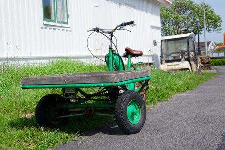 Flatbed moped parked on street of the peaceful car-free Vrango island with seaside village in Gothenburg archipelago, Vrango, Swedenの写真素材