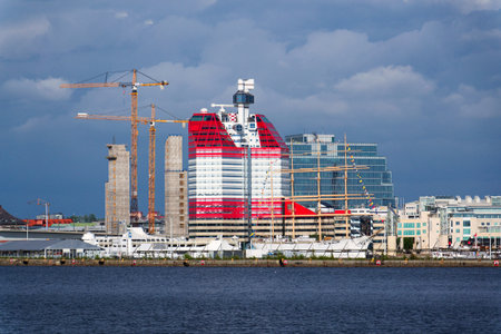 Yellow cranes on construction site of timber building Kaj 16 with hybrid concrete frames, sunny day, Lilla Bommen area on May 10, 2025 in Gothenburg, Sweden.のeditorial素材