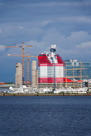 Yellow cranes on construction site of timber building Kaj 16 with hybrid concrete frames, sunny day, Lilla Bommen area on May 10, 2025 in Gothenburg, Sweden.のeditorial素材
