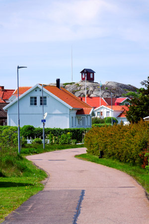 Traditional wooden houses near marina on peaceful car-free Vrango island with seaside village in Gothenburg archipelago, Swedenの写真素材