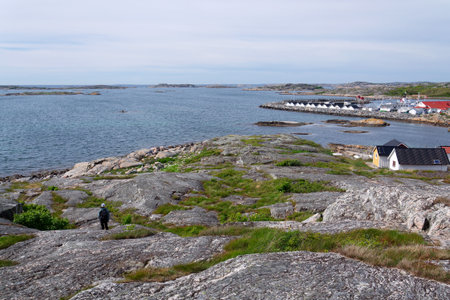 Traditional wooden houses near marina on peaceful car-free Vrango island with seaside village in Gothenburg archipelago, Swedenの写真素材