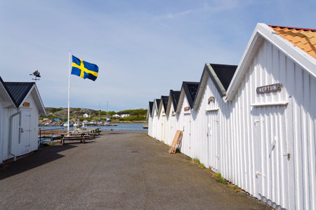 Traditional wooden houses near marina on peaceful car-free Vrango island with seaside village in Gothenburg archipelago, Swedenの写真素材