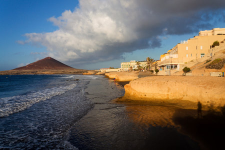 Local people walk on town beach on July 9, 2019 in El Medano, Spain.のeditorial素材