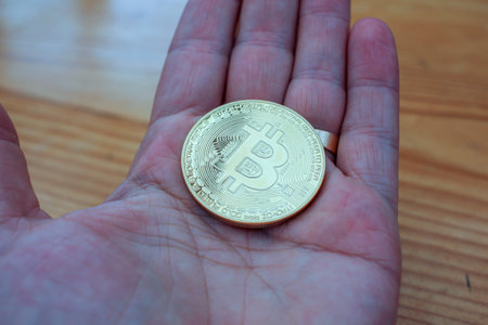 the coin of the future in the palm of my hand, bitcoinの写真素材