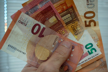 some euro notes in my hand to pay my debts