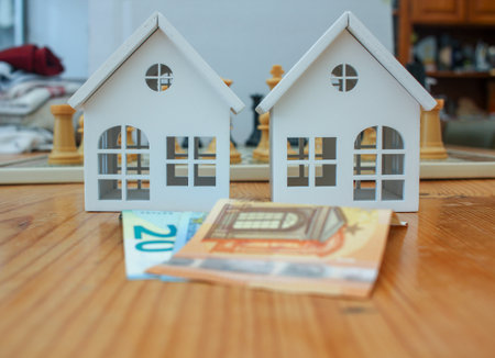 euro notes and tiny houses made of wood. Invest in real estateの写真素材