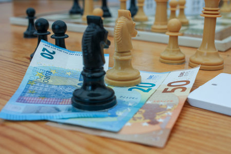 chess pieces on fifty and twenty euro notesの写真素材
